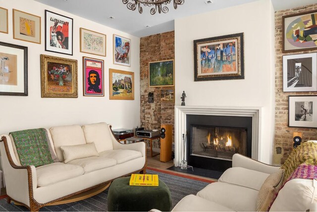 bedroom featuring ceiling fan, brick wall, carpet floors, and french doors