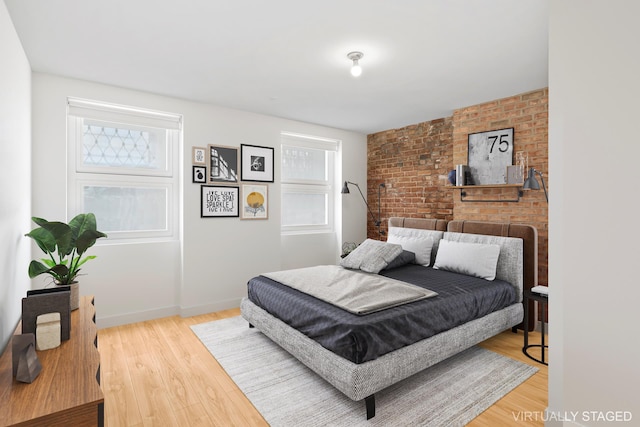 308 E 30th St Unit 1, New York City, NY 10016 - bedroom featuring wood finished floors and brick wall