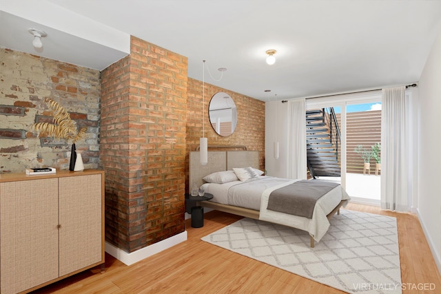 308 E 30th St Unit 1, New York City, NY 10016 - bedroom with light wood-type flooring and access to exterior