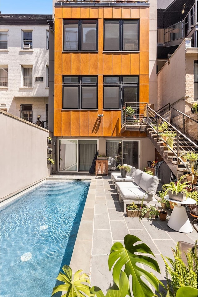 308 E 30th St Unit 1, New York City, NY 10016 - rear view of property with stairs, an outdoor pool, a patio area, and outdoor lounge area