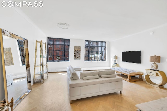 living room featuring light parquet flooring and ornamental molding