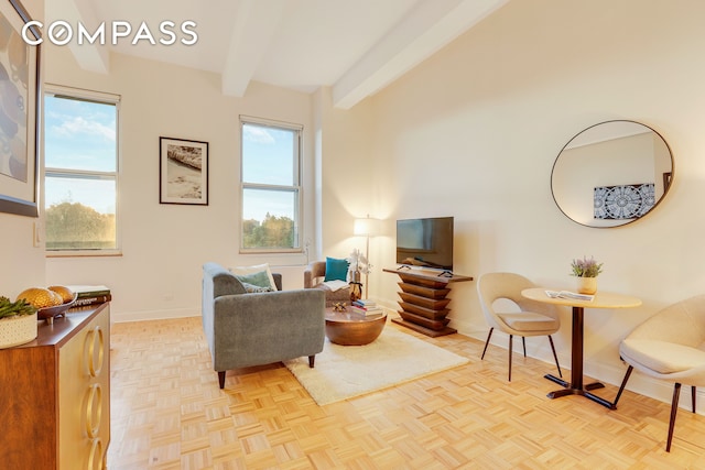 living room featuring beam ceiling and baseboards