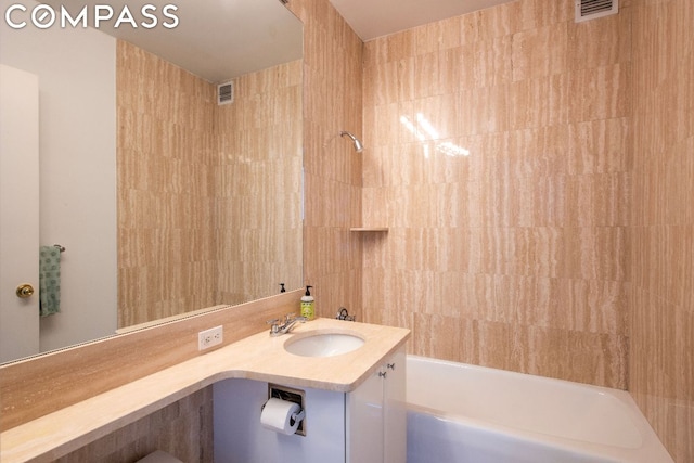 bathroom featuring vanity and washtub / shower combination