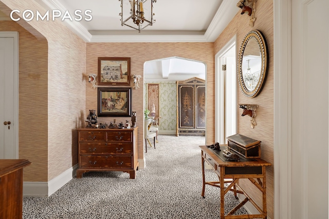 corridor with wallpapered walls, carpet flooring, baseboards, and ornamental molding