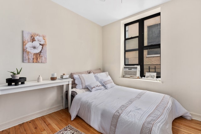 bedroom featuring cooling unit and light wood-type flooring