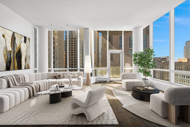 living room with hardwood / wood-style flooring and a wall of windows