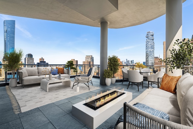 view of patio with an outdoor living space with a fire pit