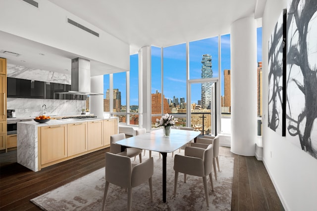 dining space with dark wood-type flooring and floor to ceiling windows