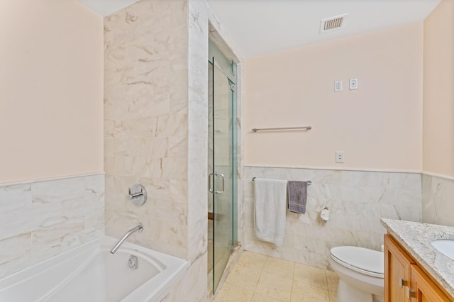 full bath featuring a wainscoted wall, tile walls, a stall shower, vanity, and a bath