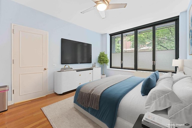 bedroom featuring light hardwood / wood-style floors and ceiling fan