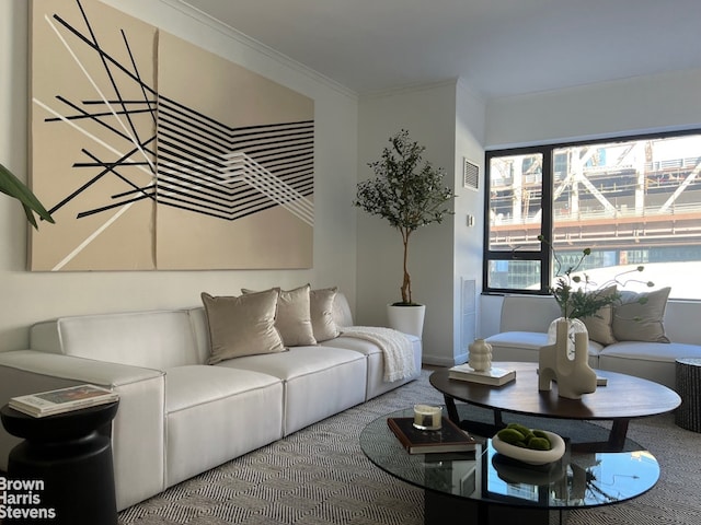 carpeted living room featuring ornamental molding