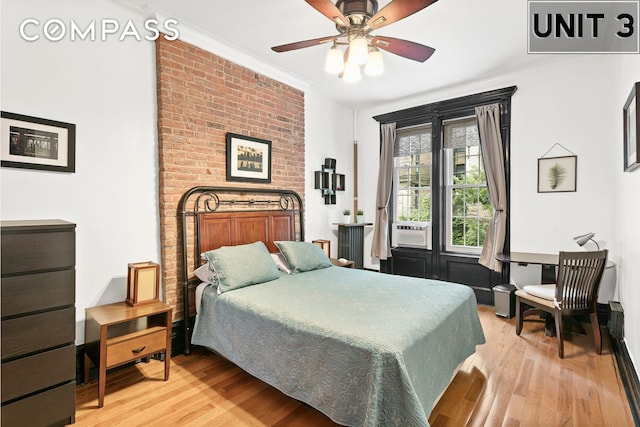 bedroom featuring ceiling fan, cooling unit, light wood-type flooring, and ornamental molding