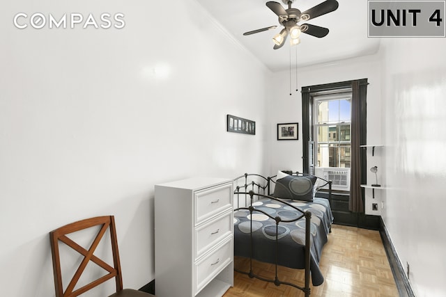 bedroom featuring ceiling fan, crown molding, and baseboards