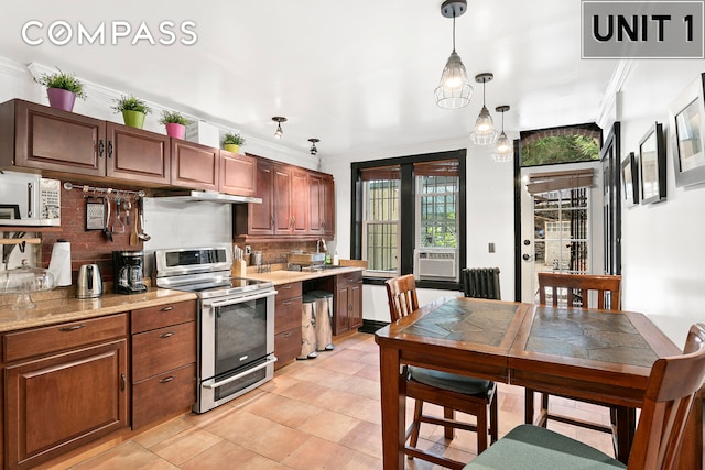 kitchen featuring hanging light fixtures, stainless steel electric range, light countertops, and crown molding