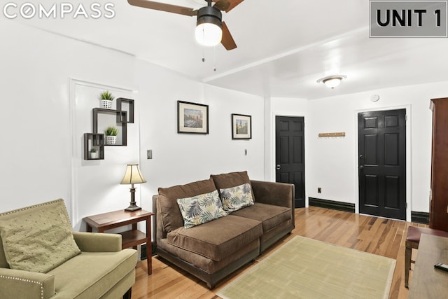 living room featuring light wood-type flooring and ceiling fan