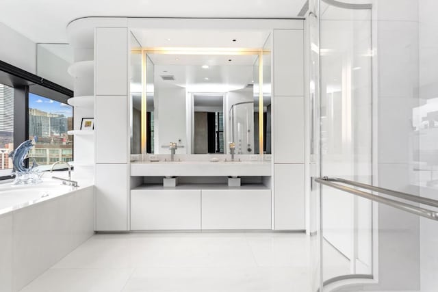 bathroom with tile patterned floors, separate shower and tub, and vanity