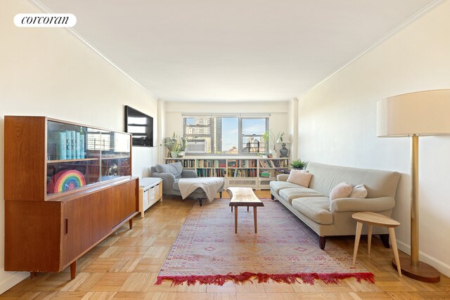 living room featuring ornamental molding and light parquet floors