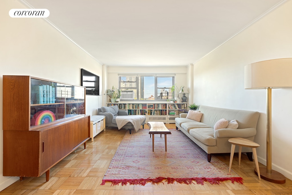 living room featuring ornamental molding and visible vents