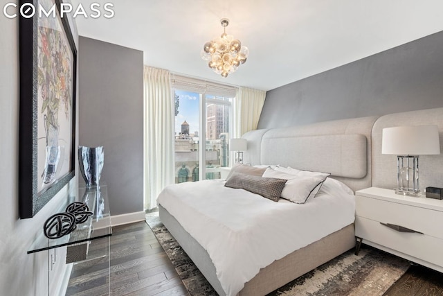 bedroom with dark hardwood / wood-style flooring and a notable chandelier