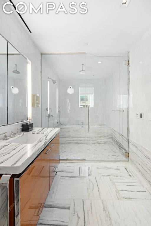 bathroom with vanity and walk in shower