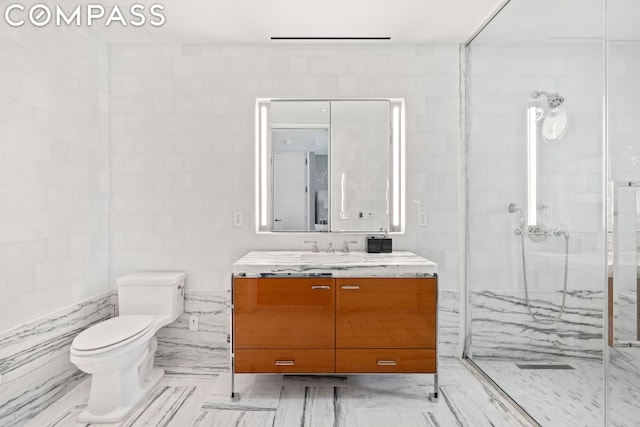 bathroom featuring vanity, tile walls, an enclosed shower, and toilet