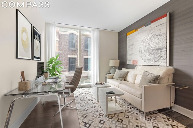 living room with a wealth of natural light, floor to ceiling windows, and light wood-type flooring