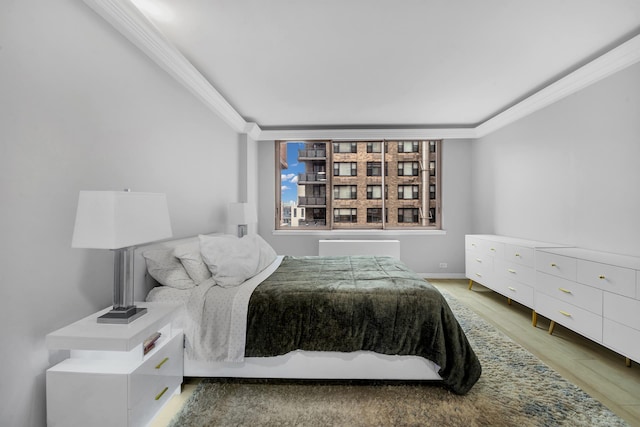 235 E 40th St Unit 24H, New York City, NY 10016 - bedroom with crown molding and light wood-style floors