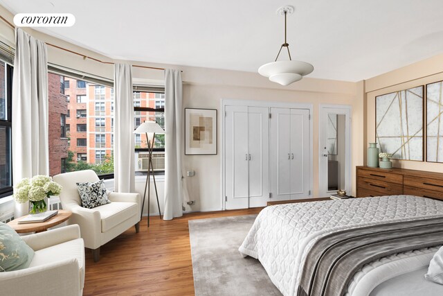 440 E 56th St Unit 6B, New York City, NY 10022 - bedroom with light wood-type flooring