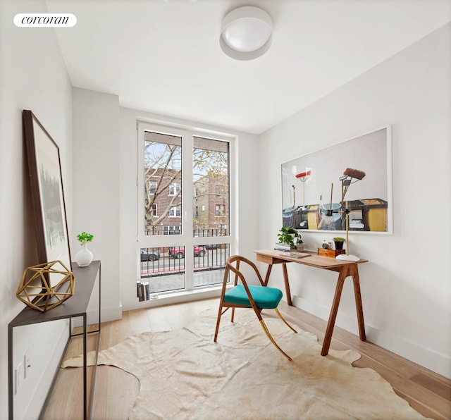 office featuring visible vents, baseboards, and wood finished floors