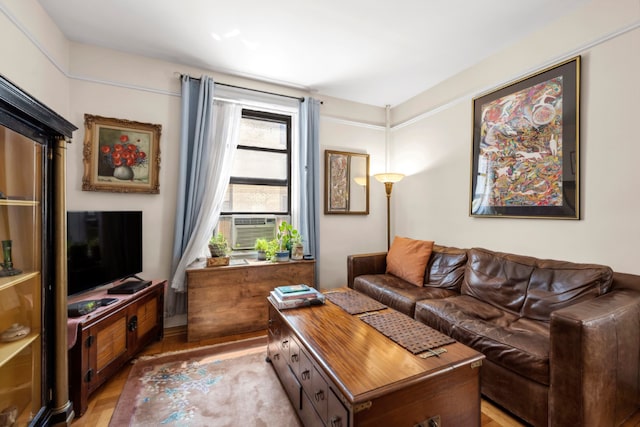 living room with cooling unit and light hardwood / wood-style floors