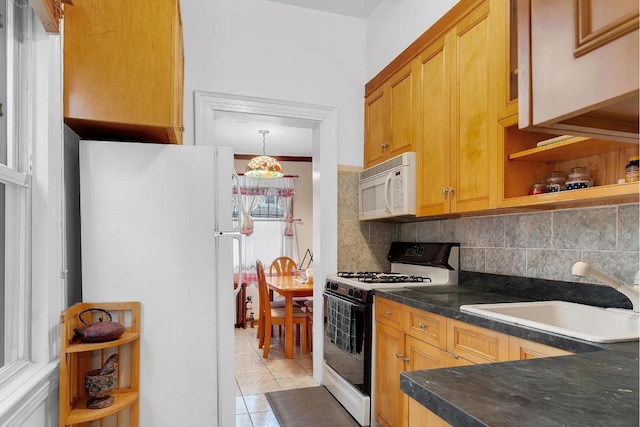 kitchen featuring a sink, backsplash, light tile patterned floors, white appliances, and open shelves