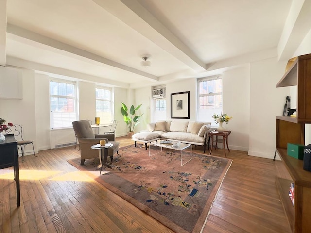 living room with beam ceiling, wood-type flooring, and a wall mounted AC