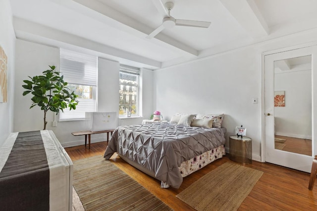 bedroom featuring beamed ceiling, ceiling fan, and hardwood / wood-style flooring