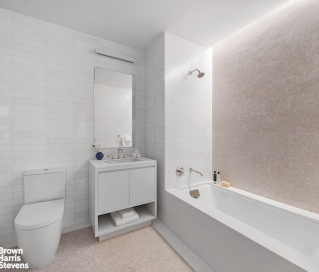 full bath featuring vanity,  shower combination, toilet, and tile walls