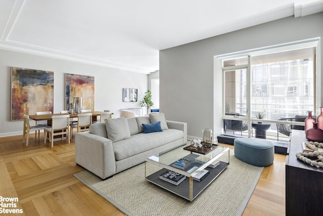 living area featuring baseboards