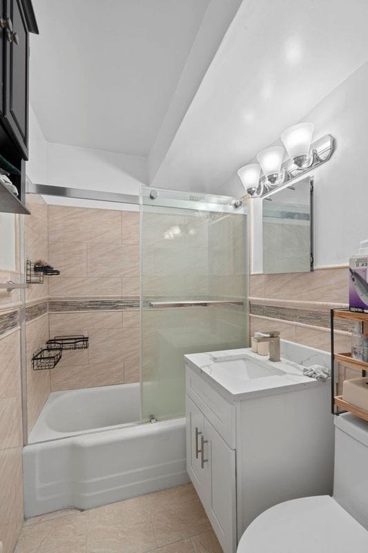 405 E 63rd St Unit 2B, New York City, NY 10065 - full bath with vanity, bath / shower combo with glass door, and tile patterned flooring