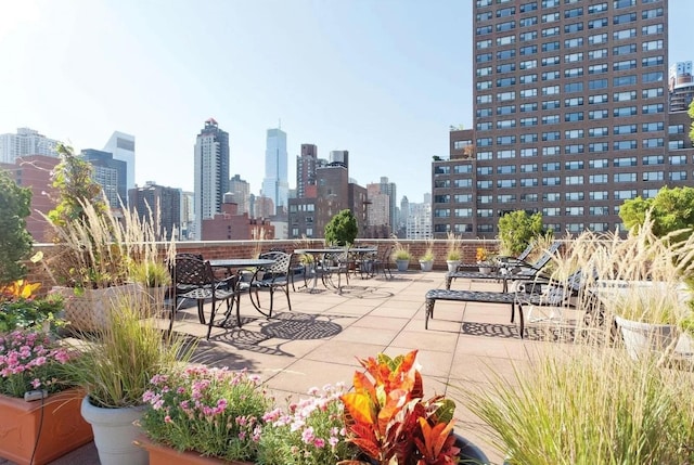 405 E 63rd St Unit 2B, New York City, NY 10065 - surrounding community with outdoor dining area, a skyline view, and a patio area