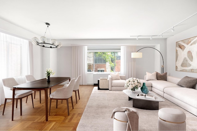 living room with a chandelier and track lighting