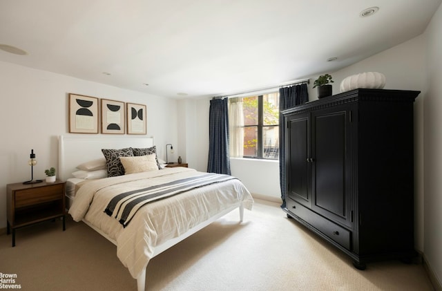 bedroom featuring light colored carpet