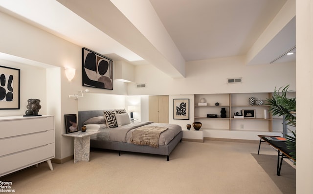 bedroom with light carpet, visible vents, and baseboards