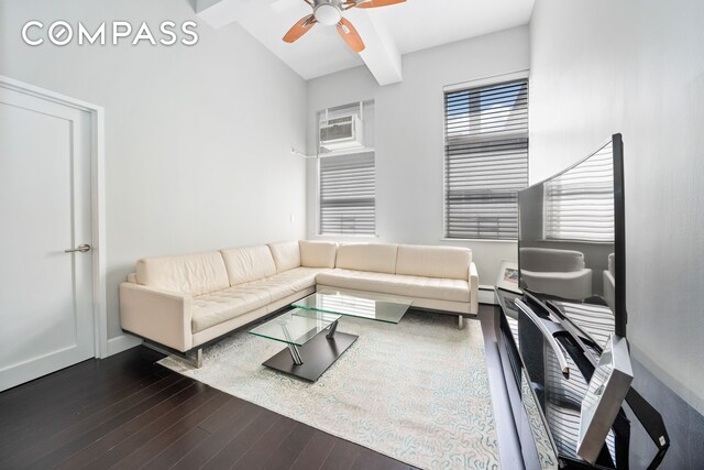 living room with dark hardwood / wood-style flooring, beamed ceiling, and a baseboard radiator