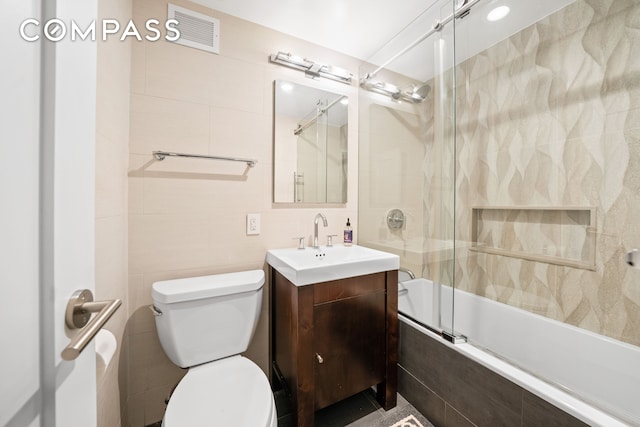 350 E 62nd St Unit 4L, New York City, NY 10065 - bathroom with tiled shower / bath, vanity, and tile walls