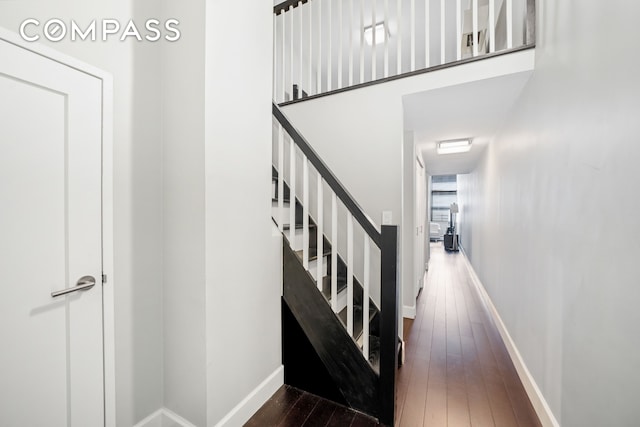 350 E 62nd St Unit 4L, New York City, NY 10065 - stairway featuring wood-type flooring and baseboards