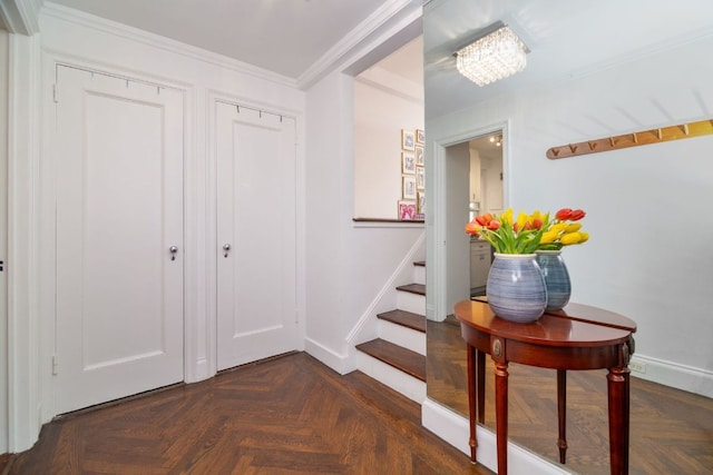 interior space with a chandelier, ornamental molding, and dark parquet floors