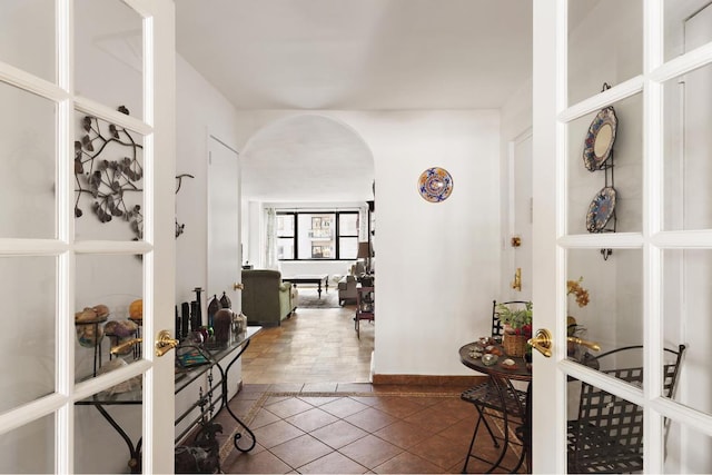 hall featuring dark tile patterned flooring