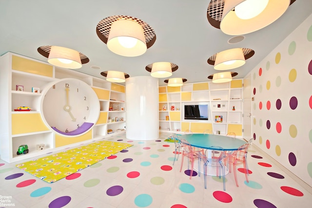 playroom with baseboards and tile patterned floors