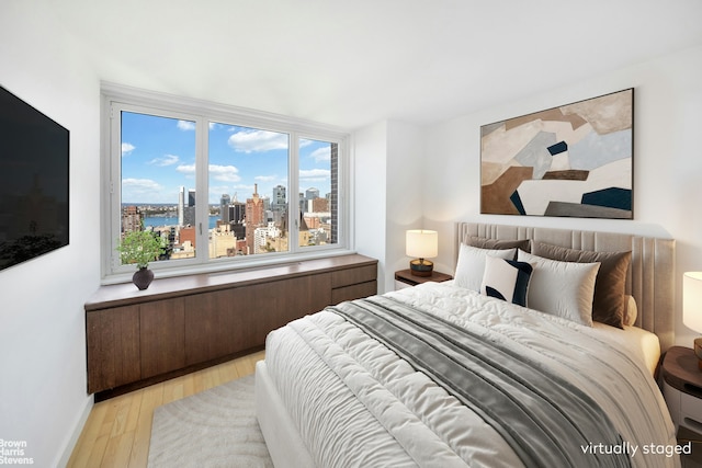 bedroom with light wood-style flooring and baseboards