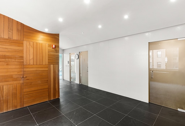 spare room with dark tile patterned floors and recessed lighting