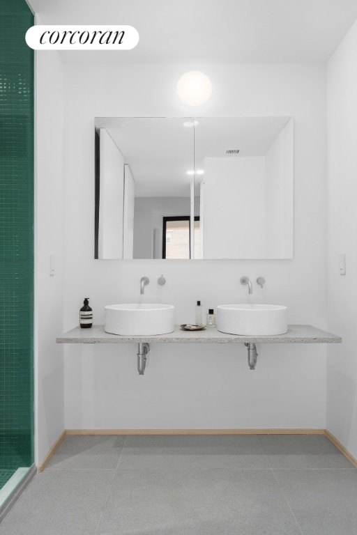 bathroom featuring sink and a shower