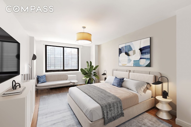 bedroom with baseboards and light wood-style floors